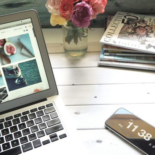 Office desk image for admin support in Wiltshire, laptop, magazines and flowers