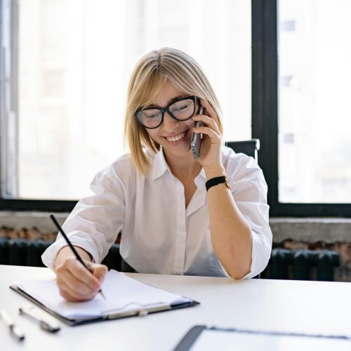 Lady on phone taking notes